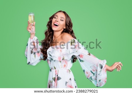 Dynamic image Profile side view photo of charming, lovely, sweet, gorgeous, adorable, good-looking lady hold glass of alcohol dance half turn isolated on vivid turquoise background