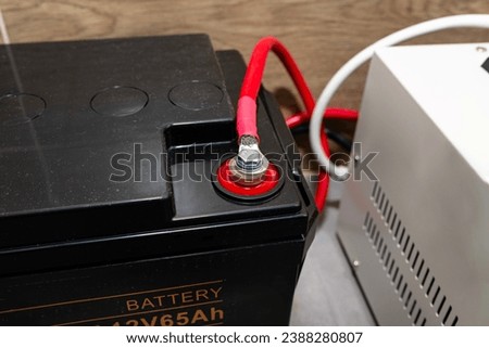 12V 65Ah battery for emergency power supply providing uninterrupted pure sinusoidal alternating voltage of 230 Volt. Royalty-Free Stock Photo #2388280807