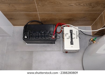 Emergency power supply with a 12V 65Ah battery providing uninterrupted pure sinusoidal alternating voltage of 230 Volt. Royalty-Free Stock Photo #2388280809