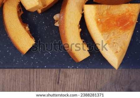pumpkin sliced with the seeds   on the stone background