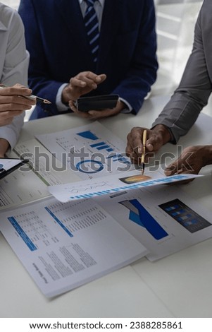 Business people meeting to analyze and discuss and brainstorm information, financial charts, office laptops, teamwork, financial consultants and accounting concepts. vertical picture