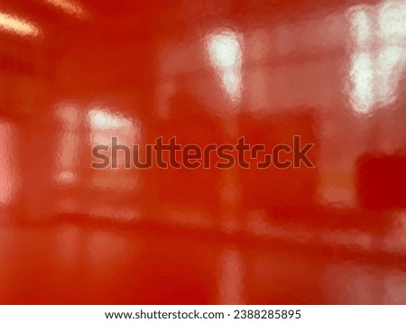 photo of orange glossy wall with a blurry reflective shiny effect that give a creative atmosphere Royalty-Free Stock Photo #2388285895