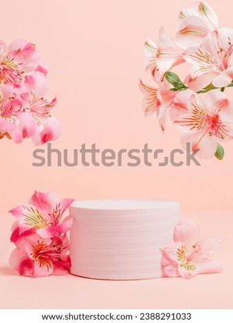 Beautiful podium with pink lily flowers on pink background. Showcase for cosmetic, design and product presentation. Valentine, mother day, women day, holiday background