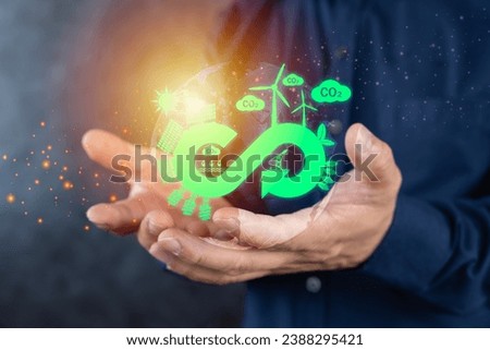 Circular economy concept. Hand holding circular economy low Polygonal on a green background. circular economy for future growth of business and design to reuse and renewable material resources.