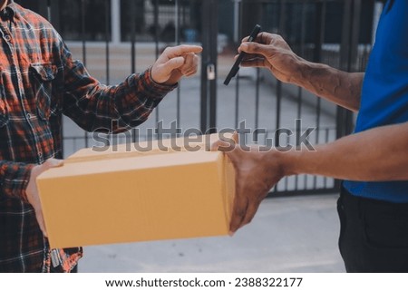 Startup small business entrepreneur of freelance Asian woman using a laptop with box Cheerful success Asian woman her hand lifts up online marketing packaging box and delivery SME idea concept