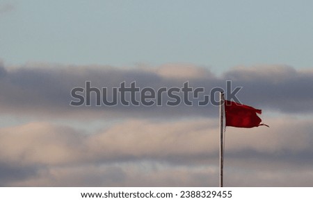City of Evpatoria (Crimea, Crimean Peninsula) Red flag prohibiting swimming on the beach near the Black Sea coast.