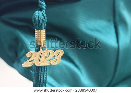 Graduation cap from 2023 in emerald green celebration new career achievement hard work Royalty-Free Stock Photo #2388340307