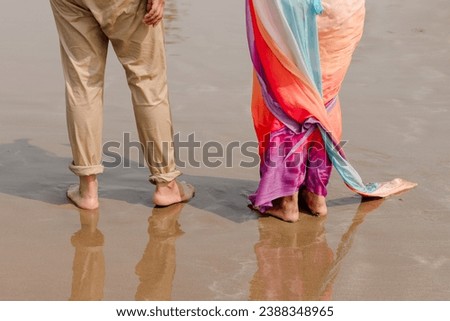 Full body back view young lovely couple two friends family man woman in casual clothes hold hands walking stroll together at sunrise over sea beach ocean outdoor exotic seaside in summer day evening