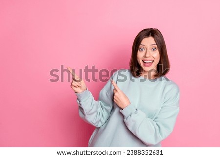 Photo of youth cheerful lady indicate fingers empty space proposition suggest direct isolated over pink color background