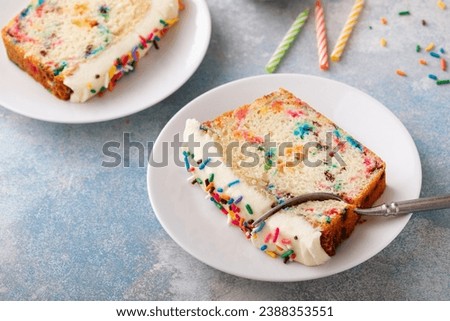 Birthday cake loaf cake or funfetti quick bread with sprinkles and buttercream frosting Royalty-Free Stock Photo #2388353551