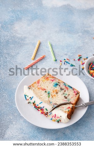 Birthday cake loaf cake or funfetti quick bread with sprinkles and buttercream frosting Royalty-Free Stock Photo #2388353553