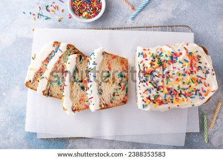 Birthday cake loaf cake or funfetti quick bread with sprinkles and buttercream frosting Royalty-Free Stock Photo #2388353583