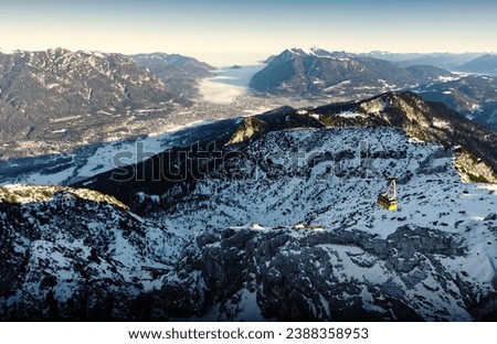 mountain landscape and aerial view of Garmisch-Partenkirchen, Bavaria, Kreuzeck, Germany, fog cloud enters the valley Royalty-Free Stock Photo #2388358953