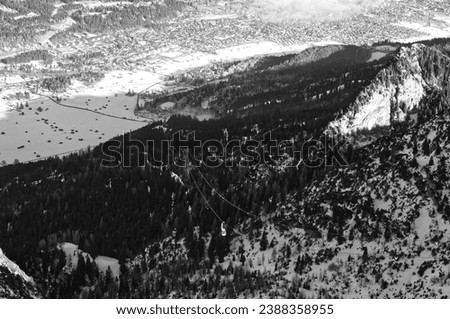 mountain landscape and aerial view of Garmisch-Partenkirchen, Bavaria, Kreuzeck, Germany, fog cloud enters the valley Royalty-Free Stock Photo #2388358955
