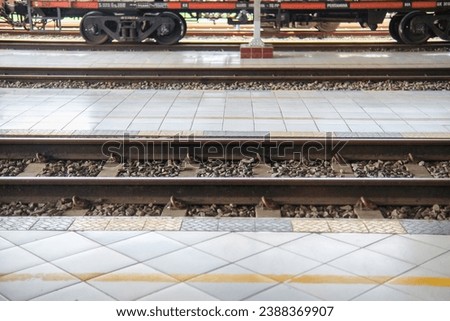 Close up on part of railroad track from side view on a train station Royalty-Free Stock Photo #2388369907