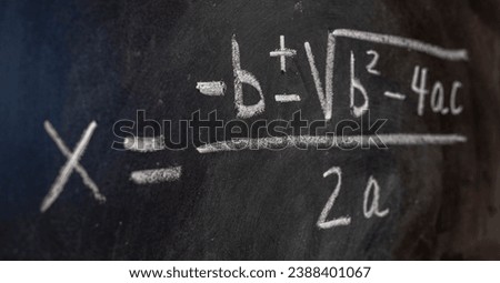Quadratic equations handwritten on a blackboard with chalk, mathematical formulas