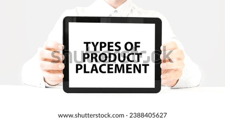 Text TYPES OF PRODUCT PLACEMENT on tablet display in businessman hands on the white background. Business concept