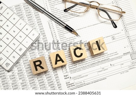 RACI word on wooden blocks with calculator and pen Royalty-Free Stock Photo #2388405631