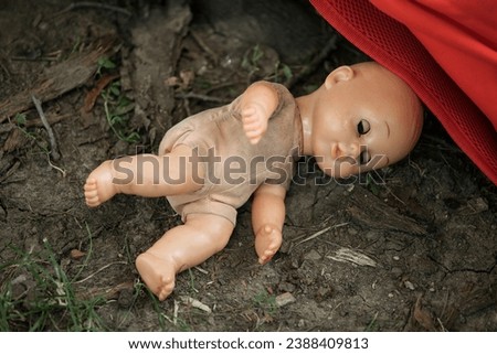 Old broken doll on ground, abandoned baby doll  Royalty-Free Stock Photo #2388409813