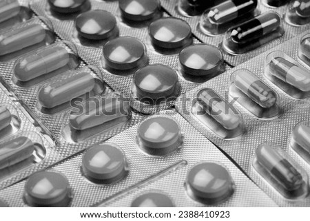medical pills on black and white background Royalty-Free Stock Photo #2388410923