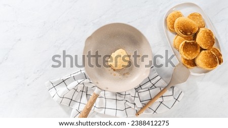 Flat lay. Preparing eggnog pancakes in a nonstick frying pan. Royalty-Free Stock Photo #2388412275