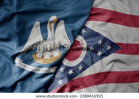 big waving colorful national flag of ohio state and flag of louisiana state . macro