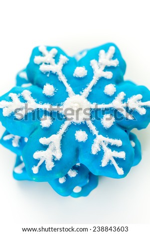 Frosted blue sugar cookies in shape of snowflakes.