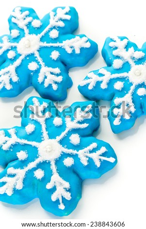 Frosted blue sugar cookies in shape of snowflakes.