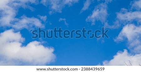 Majestic cumulus clouds float across the endless sky, their graceful forms painting a mesmerizing canvas of beauty and grandeur. Clouds are beautiful in their ever-changing shape and size. Close-up. Royalty-Free Stock Photo #2388439659