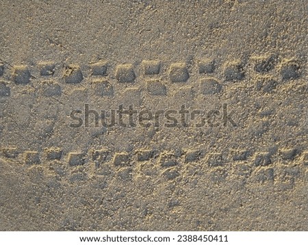 Sand background and motorbike tire tread motif
