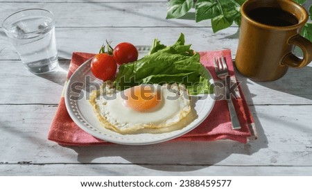 Sunny side up and coffee.A sunny room and a white wood table. Royalty-Free Stock Photo #2388459577