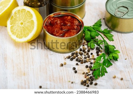 Picture of tasty squids in American Salsa on background with greens and lemon