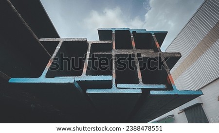 Steel beams production. Metal girders stack on project construction , steel h-beam, selective focus, Raw materials used in building construction. Royalty-Free Stock Photo #2388478551