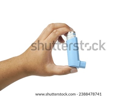 Modern blue inhalers hold by hand on white background Royalty-Free Stock Photo #2388478741