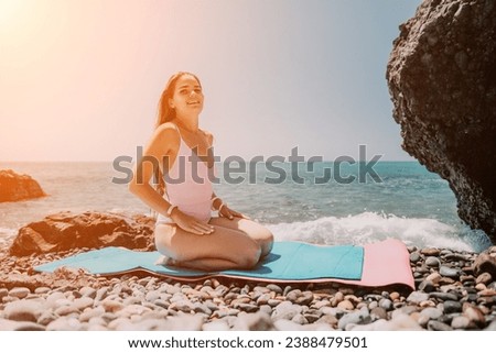 Woman sea fitness. Happy woman with long hair, fitness instructor in white bikini doing stretching and pilates on yoga mat near the sea. Female fitness yoga routine concept. Healthy lifestyle.