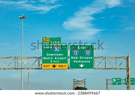 sign at highway interstate downtown metro airport to 110 north and direction New Orleans to highway 10 and 12 in Baton Rouge, Louisiana Royalty-Free Stock Photo #2388499667