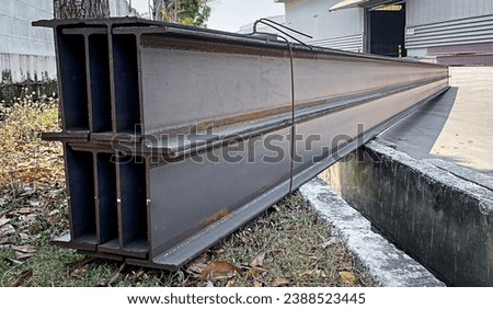 Steel beams production. Metal girders stack on project construction , steel h-beam, selective focus, Raw materials used in building construction. Royalty-Free Stock Photo #2388523445