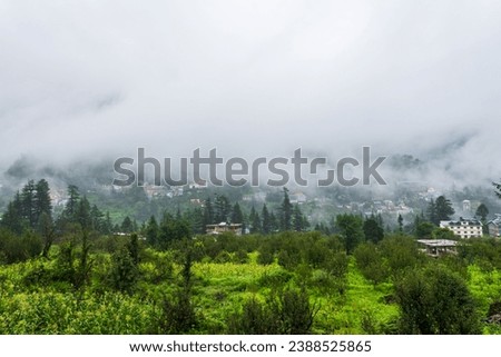Old Manali town shrouded in misty clouds in Monsoon season. It is a popular Heaven for back packers and nature lovers for its natural beauty of Himalayas in Kullu region. Royalty-Free Stock Photo #2388525865