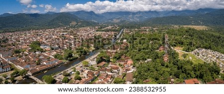 Panoramic aerial view to historic town Paraty and river, green mountains and white clouds in backgro