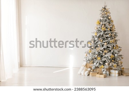 Christmas tree with gifts decorated with toys for new year