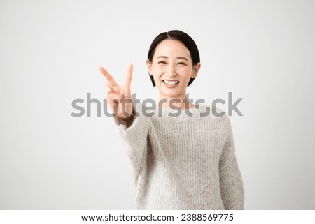 Lifestyle image of a young woman wearing knitwear