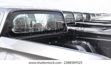 new grey SUV PICKUP vehicle, back view. Photography of a many, a lot modern pickup. made in Japan. parking in long perspective. back, rear view.  Royalty-Free Stock Photo #2388589525