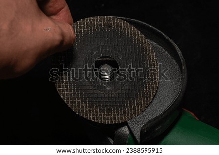 Master installs a disc on an angle grinder
