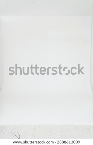 A photo studio with a white cyclorama for a professional photo shoot. Equipment for photography.