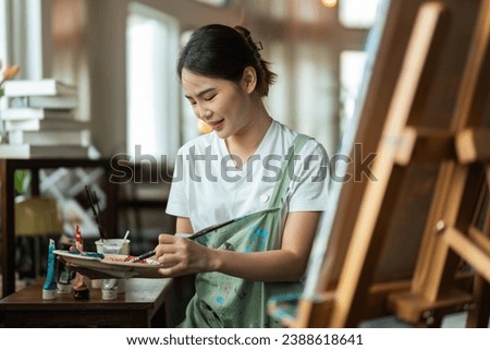 The artist is thinking about his painting with brush painting picture art, creativity, artistic and artwork, painting, Colorful artist brush and paint palette concept