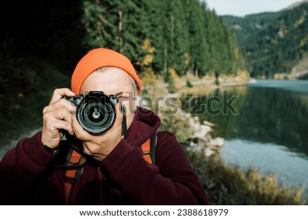 photographer with camera, searching for card and composition