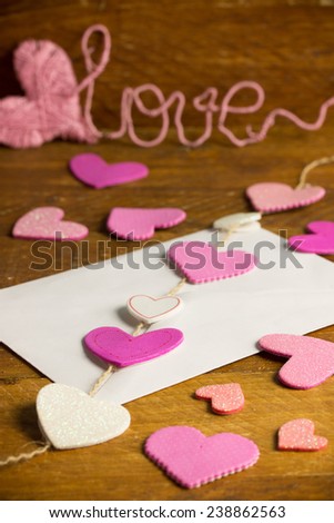 love letter with pink and white hearts and a text love in the background
