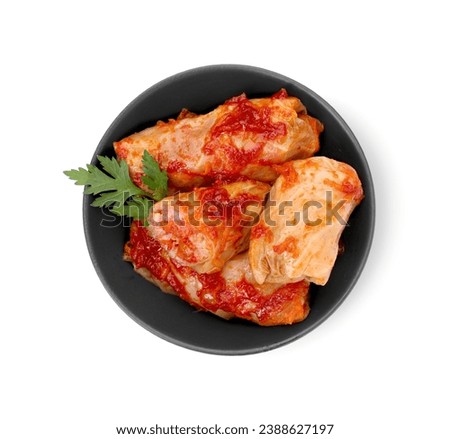 Bowl of delicious stuffed cabbage rolls cooked with homemade tomato sauce isolated on white, top view