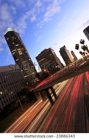 Los Angeles highway at sunset with traffic as trails of light