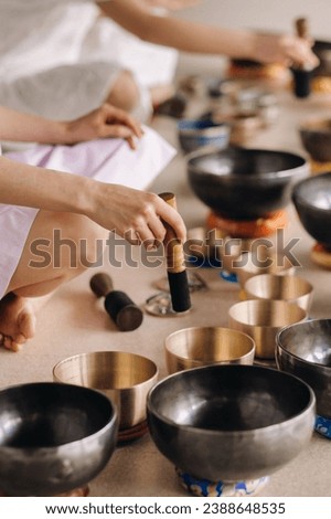 Close-up of a Tibetan singing bowl in your hands - Translation of mantras: transform your impure body, speech and mind into a pure exalted body, speech and mind of a Buddha.